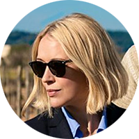 Miranda Blake has a blonde bob and is wearing dark sunglasses